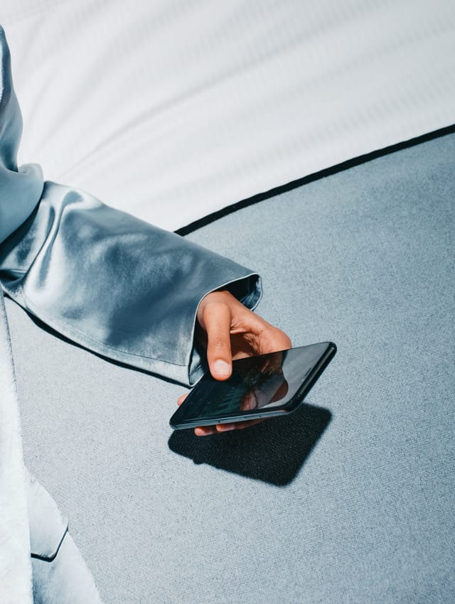 Close-up of a hand reaching for a phone